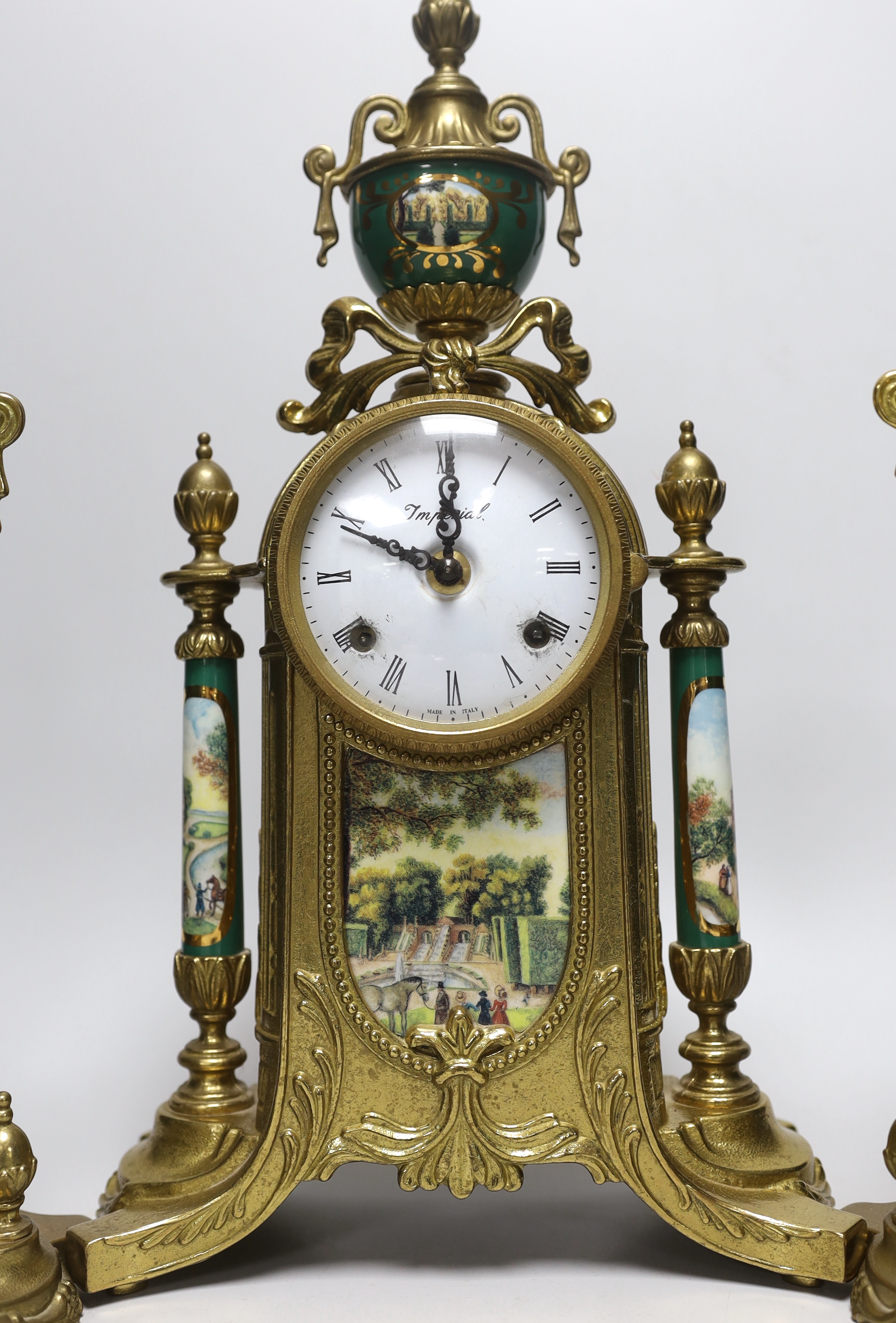 A three piece brass and porcelain clock garniture, clock 43cm high